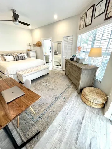 a living room with furniture a bed and a window