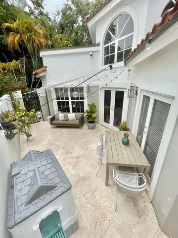 a view of a house with many windows and a yard