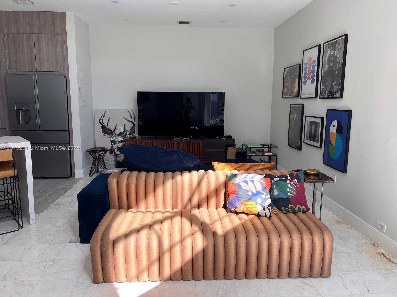 3070 Allamanda Street, Unit J Miami, FL 33133 - Photo 4 of 22 a bedroom with a bed and a flat screen tv