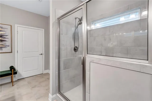 a bathroom with a glass shower door