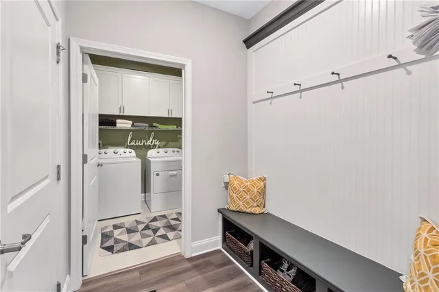 a view of a hallway with wooden floor and a cabinet
