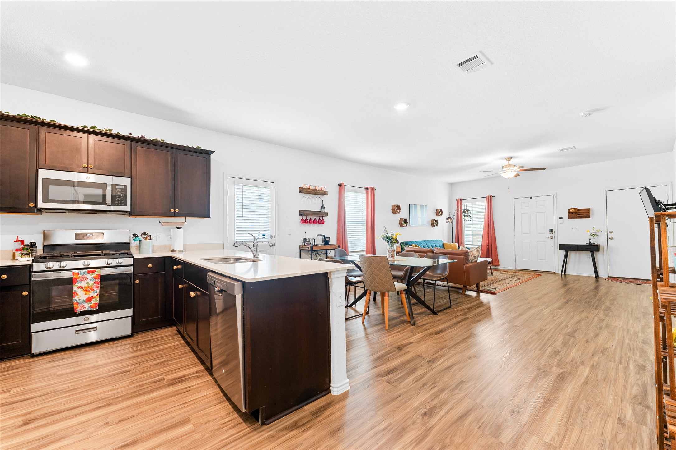6009 Jagger Avenue Austin, TX 78747 - Photo 11 of 24 a kitchen with stainless steel appliances granite countertop wooden floors and view living room
