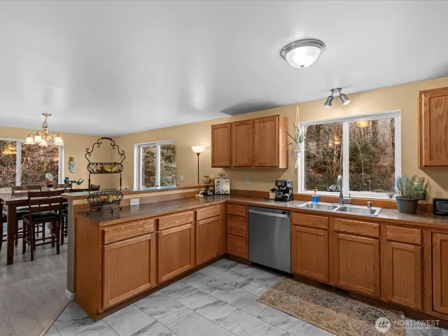 a kitchen with granite countertop a refrigerator stove and sink
