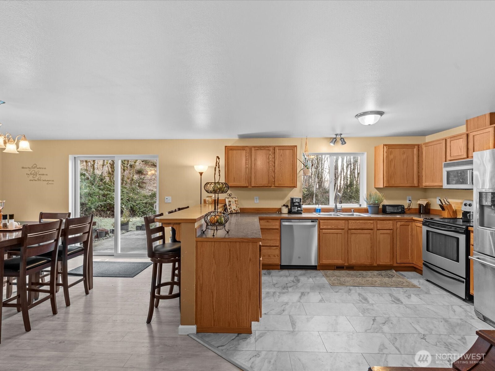 218-38 Bowen Road Mossyrock, WA 98564 - Photo 9 of 40 a kitchen with sink a stove and chairs with wooden floor