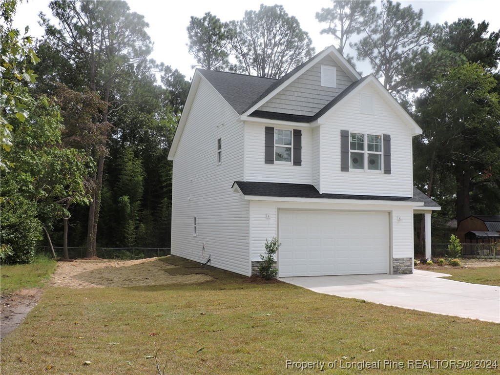 360 Summerhill Road Fayetteville, NC 28303 - Photo 3 of 9 a front view of a house with a yard and garage