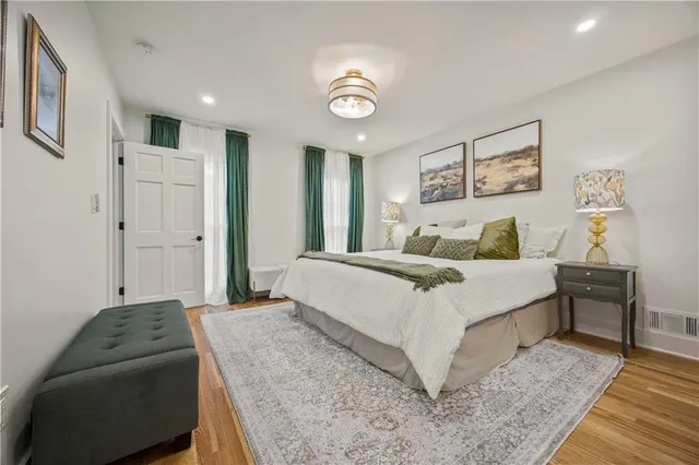 a bedroom with a bed and a lamp on table