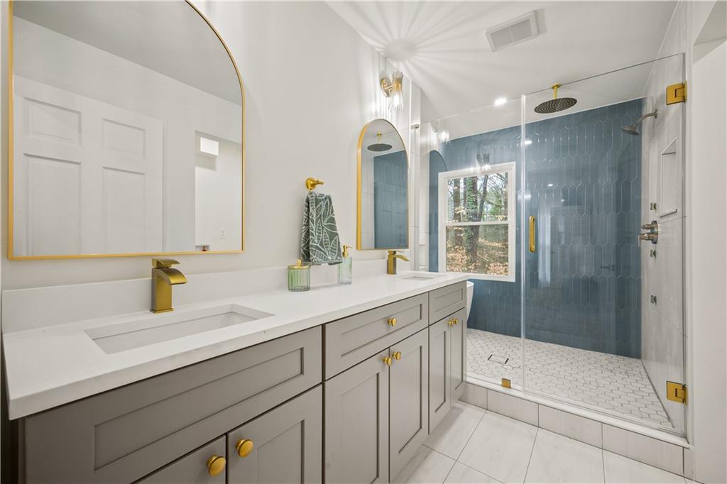 2433 Helmsdale Drive Northeast Atlanta, GA 30345 - Photo 19 of 42 a bathroom with a tub sink and mirror