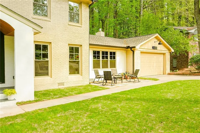 a front view of house with yard and outdoor seating