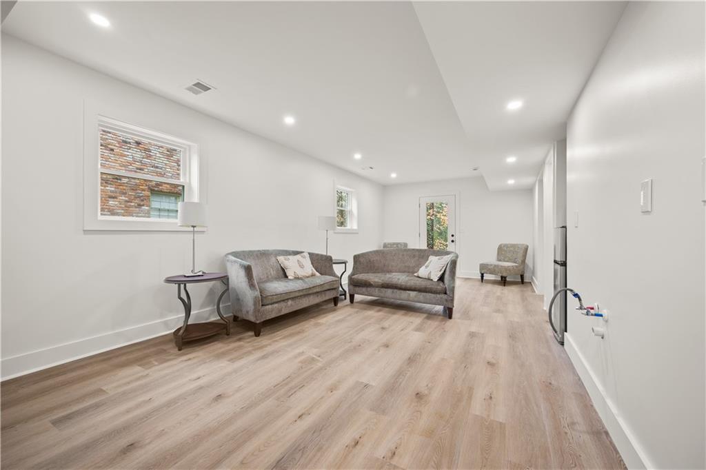 2433 Helmsdale Drive Northeast Atlanta, GA 30345 - Photo 22 of 42 a living room with furniture and a wooden floor