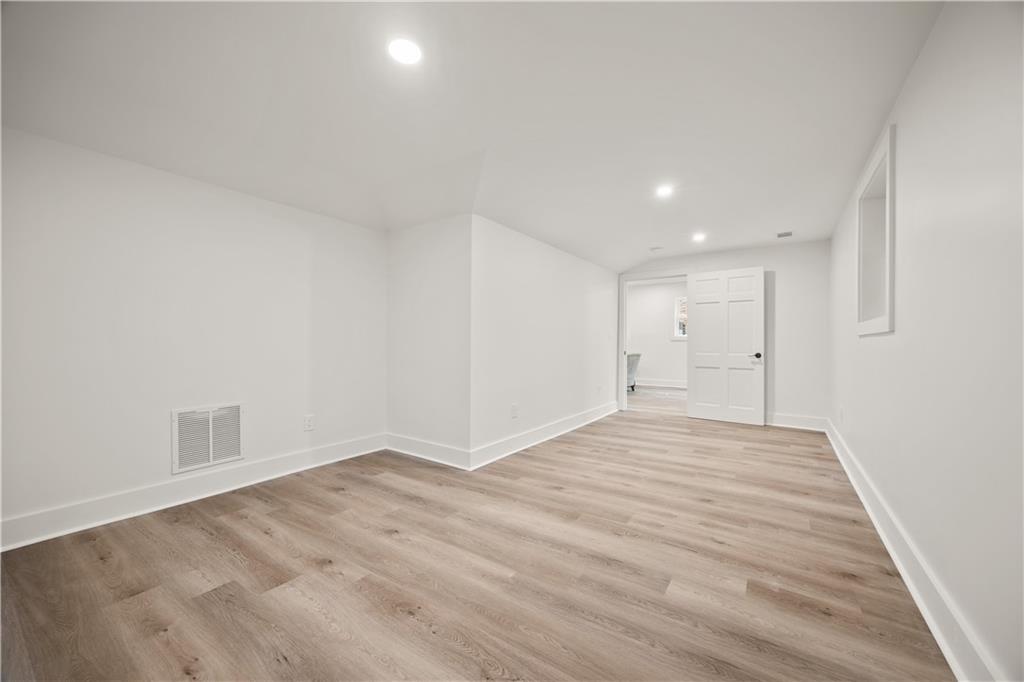 2433 Helmsdale Drive Northeast Atlanta, GA 30345 - Photo 24 of 42 a view of empty room with wooden floor