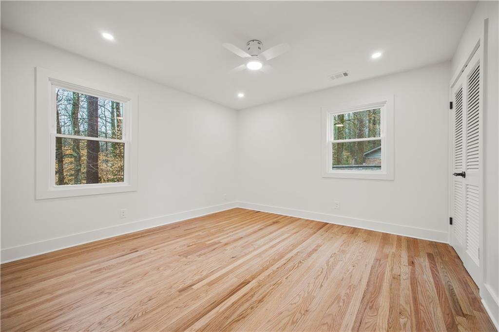 2433 Helmsdale Drive Northeast Atlanta, GA 30345 - Photo 40 of 42 a view of empty room with wooden floor and fan