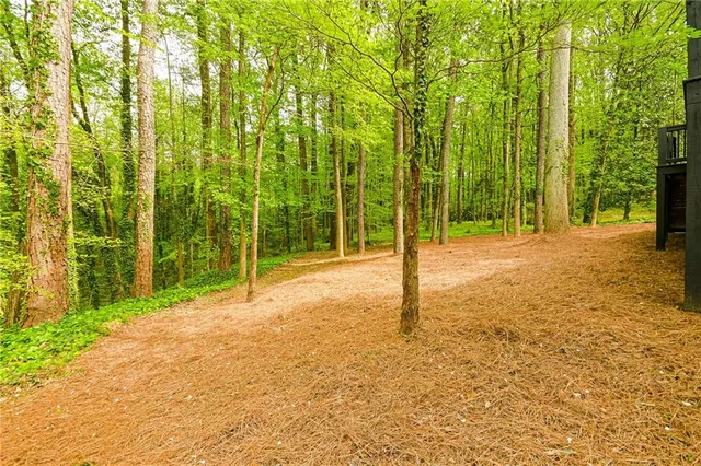 a backyard of a house with lawn chairs