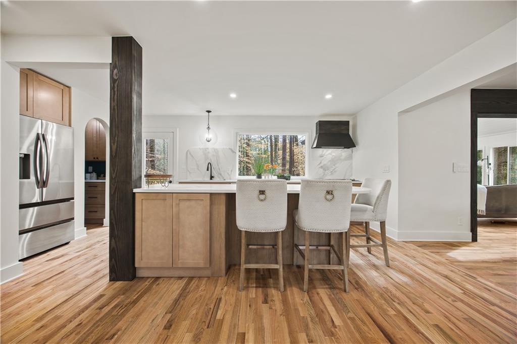 2433 Helmsdale Drive Northeast Atlanta, GA 30345 - Photo 8 of 42 a kitchen with stainless steel appliances a dining table chairs refrigerator and sink