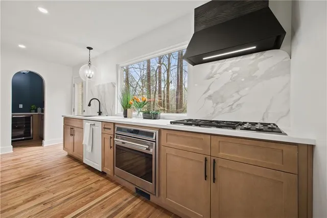 a kitchen with a stove a sink and a refrigerator