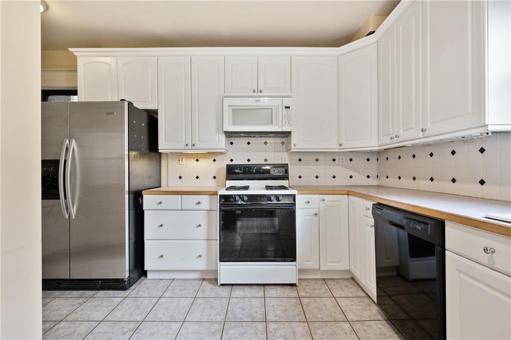 514 Park Road Ambridge, PA 15003 - Photo 7 of 25 a kitchen with cabinets stainless steel appliances and a sink