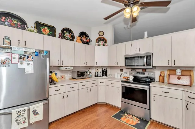 a kitchen with a white cabinets and white appliances
