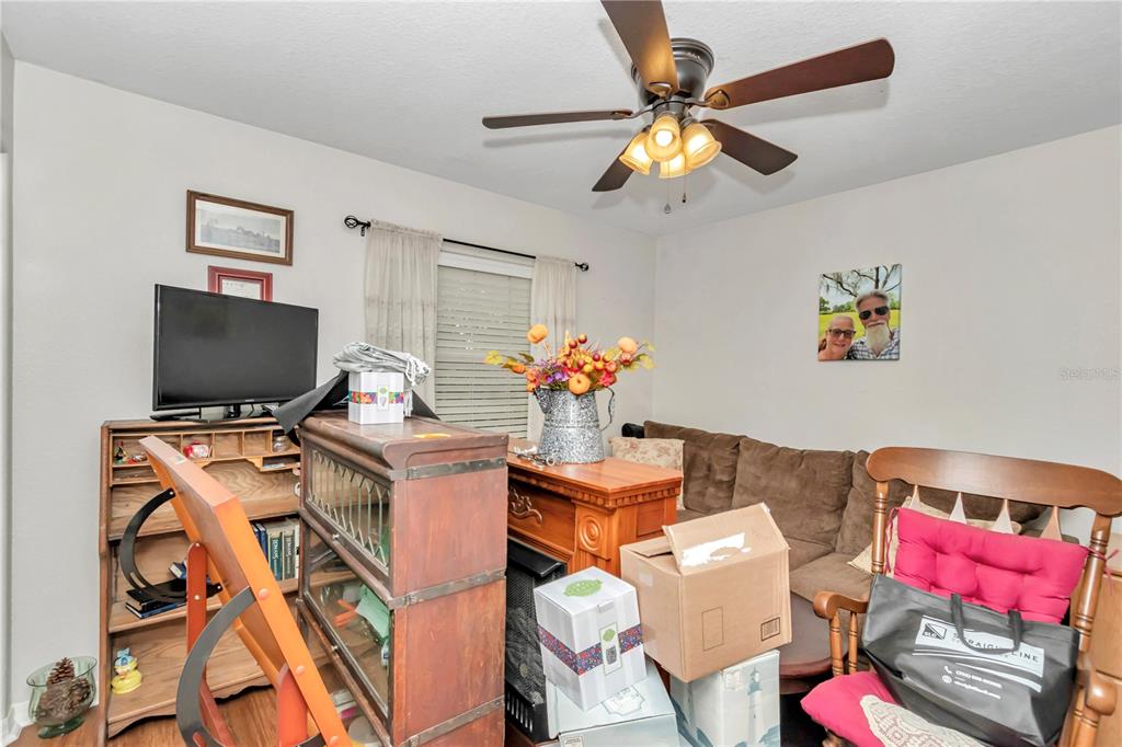 10086 Southwest 62nd Ter Road Ocala, FL 34476 - Photo 22 of 40 a living room with furniture and flat screen tv