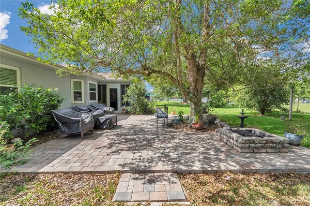 a view of a backyard with table and chairs