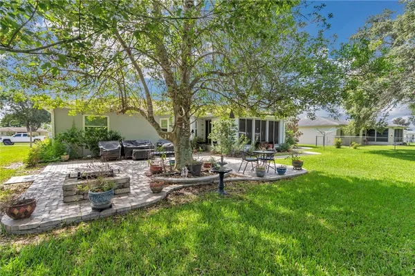 a view of backyard of house with outdoor seating and green space