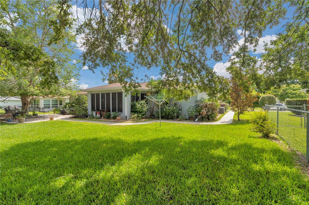 10086 Southwest 62nd Ter Road Ocala, FL 34476 - Photo 32 of 40 a backyard of a house with table and chairs