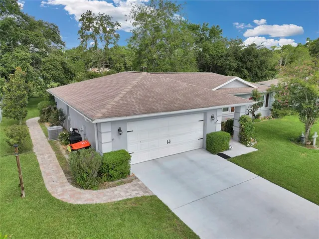a aerial view of a house sitting in middle of the green field