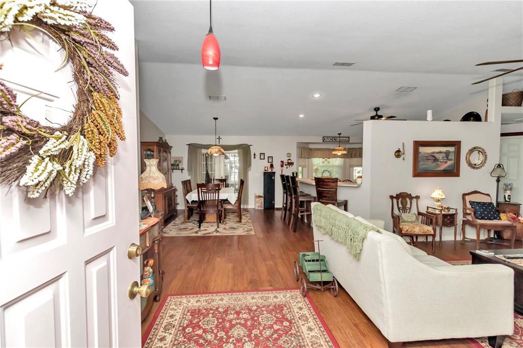 10086 Southwest 62nd Ter Road Ocala, FL 34476 - Photo 4 of 40 a living room with furniture and a wooden floor