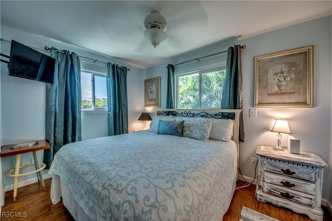 3315 Franzone Road St. James City, FL 33956 - Photo 12 of 37 a bedroom with a bed and a tv on table