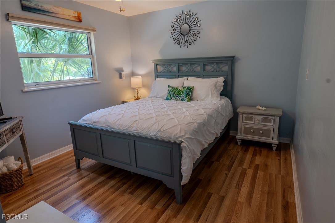 3315 Franzone Road St. James City, FL 33956 - Photo 25 of 37 a bed sitting in a bedroom next to a window