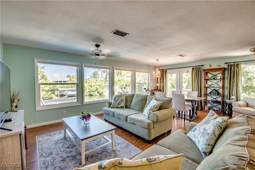 3315 Franzone Road St. James City, FL 33956 - Photo 8 of 37 a living room with furniture and a large window