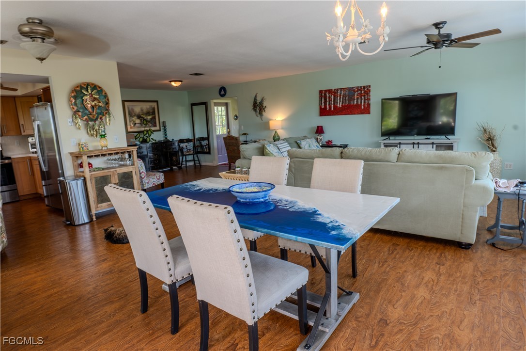 3315 Franzone Road St. James City, FL 33956 - Photo 9 of 37 a view of a dining room with furniture wooden floor and chandelier