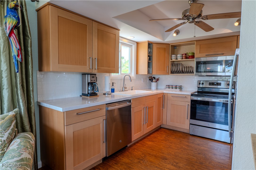 3315 Franzone Road St. James City, FL 33956 - Photo 10 of 37 a kitchen with stainless steel appliances granite countertop a sink stove and refrigerator