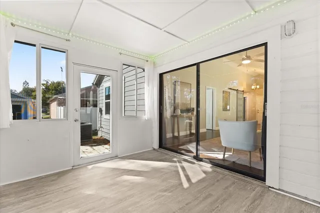 a view of an entryway with wooden floor and windows