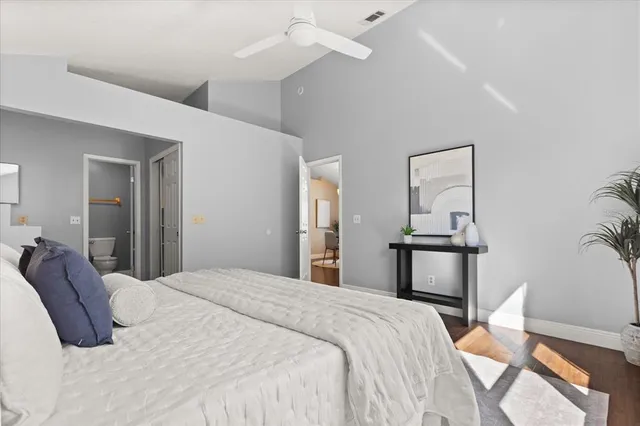 a bedroom with a bed and a painting on the wall