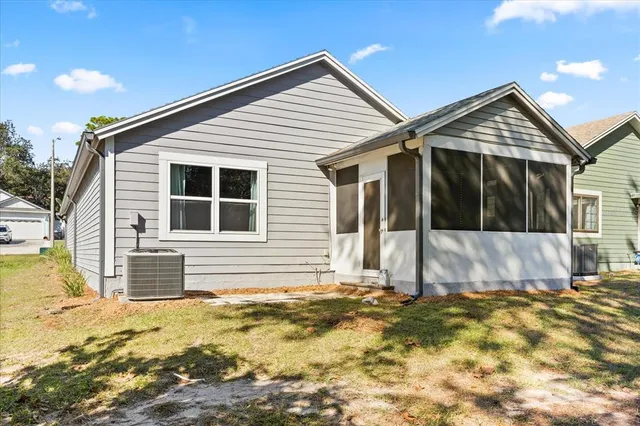 a view of house with backyard of the house