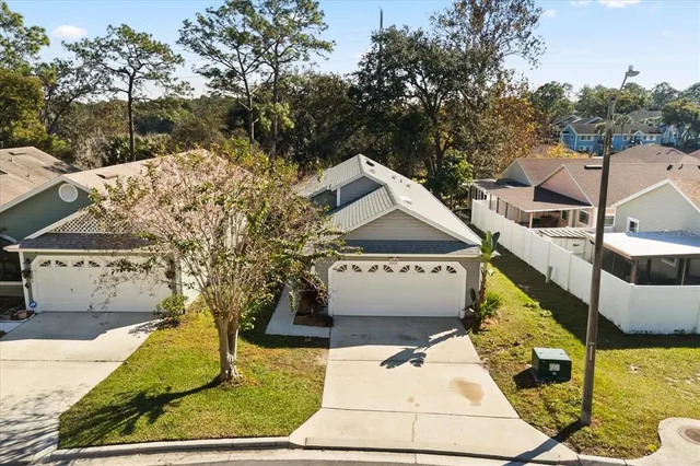 an aerial view of a house with a yard