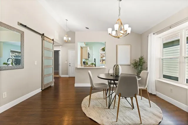 a view of a dining room with furniture wooden floor and a chandelier