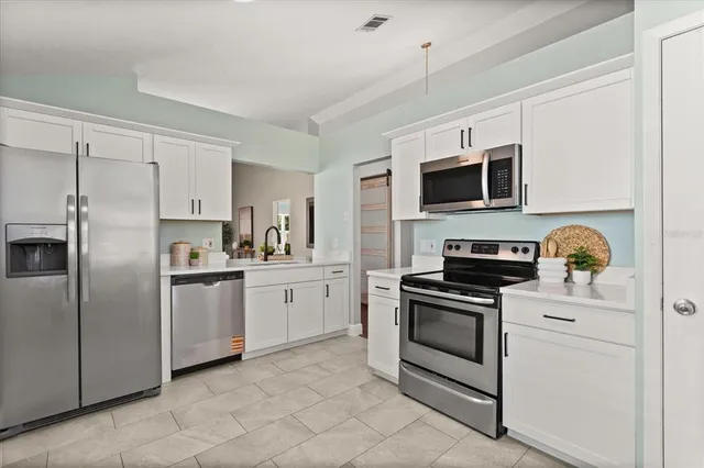 a kitchen with cabinets stainless steel appliances and counter space