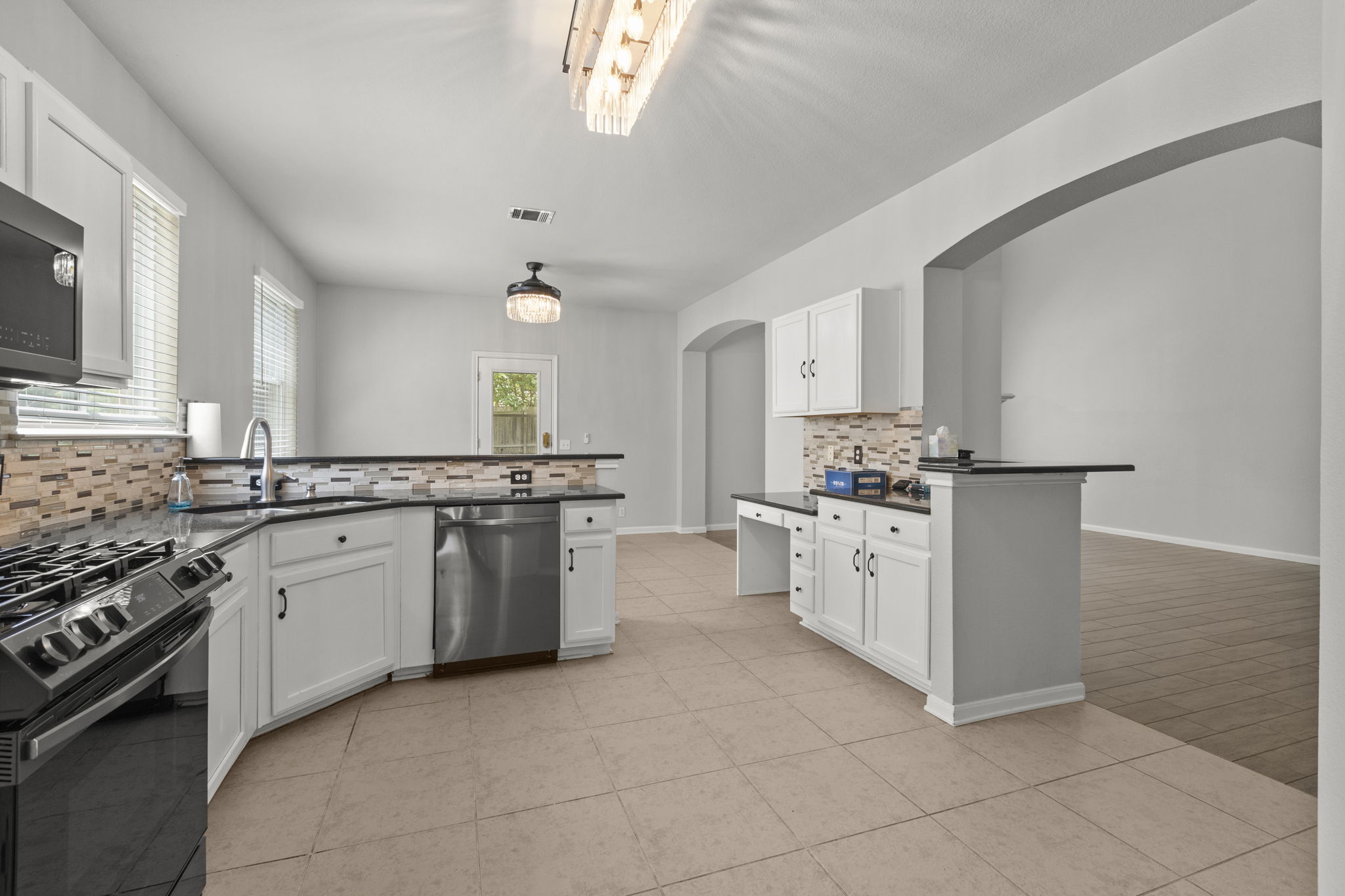 1100 Vanderbilt Circle Pflugerville, TX 78660 - Photo 11 of 39 a kitchen with granite countertop white cabinets and white appliances