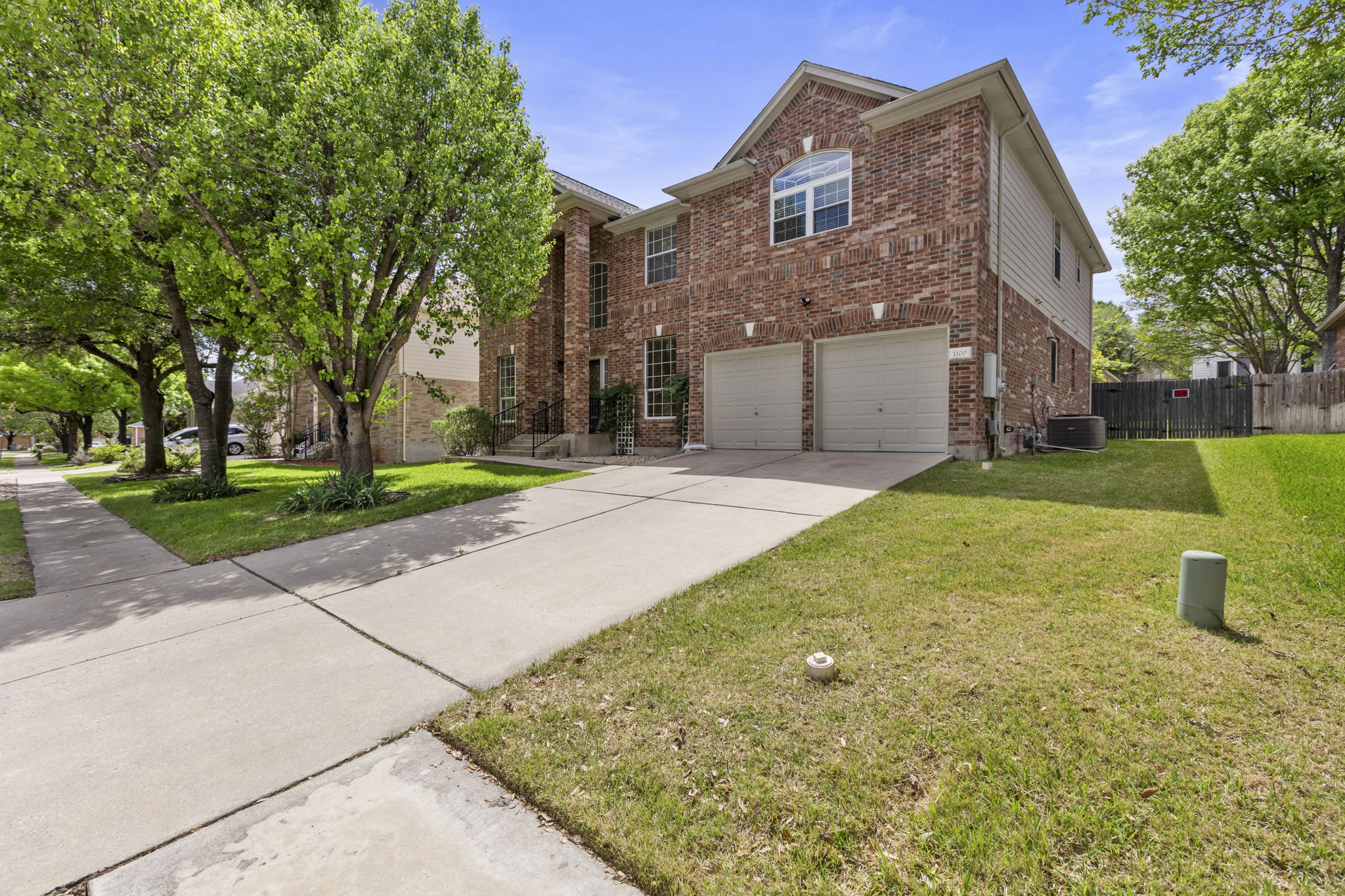 1100 Vanderbilt Circle Pflugerville, TX 78660 - Photo 2 of 39 a front view of a building with a garden