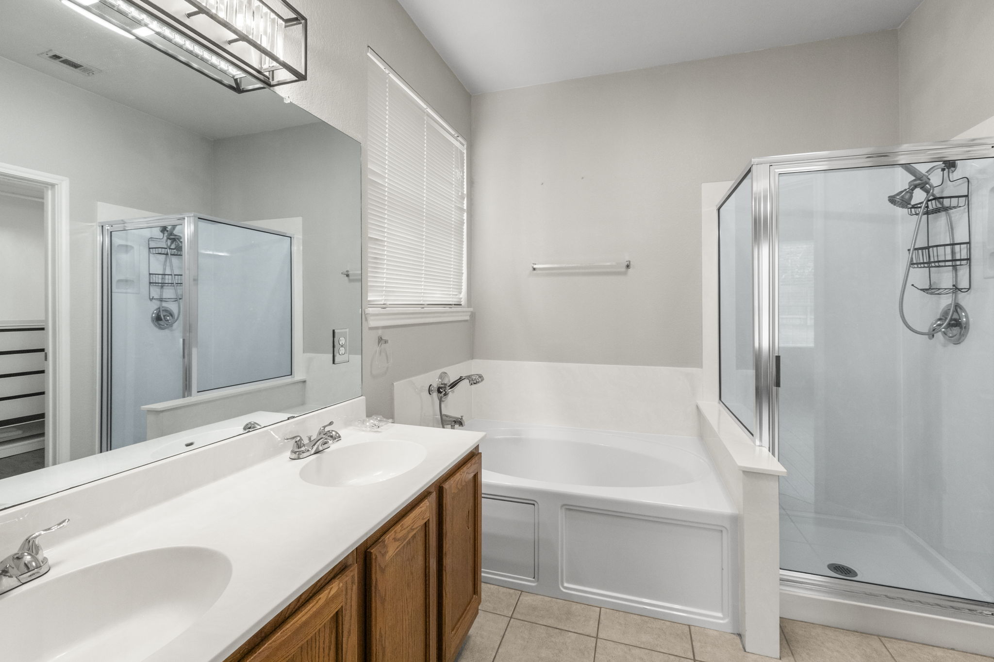 1100 Vanderbilt Circle Pflugerville, TX 78660 - Photo 25 of 39 a bathroom with a tub sink and mirror
