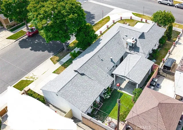 an aerial view of residential houses with yard