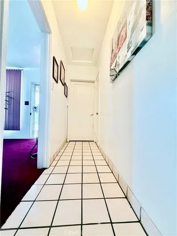 a bedroom with a bed a mirror on dresser and a window