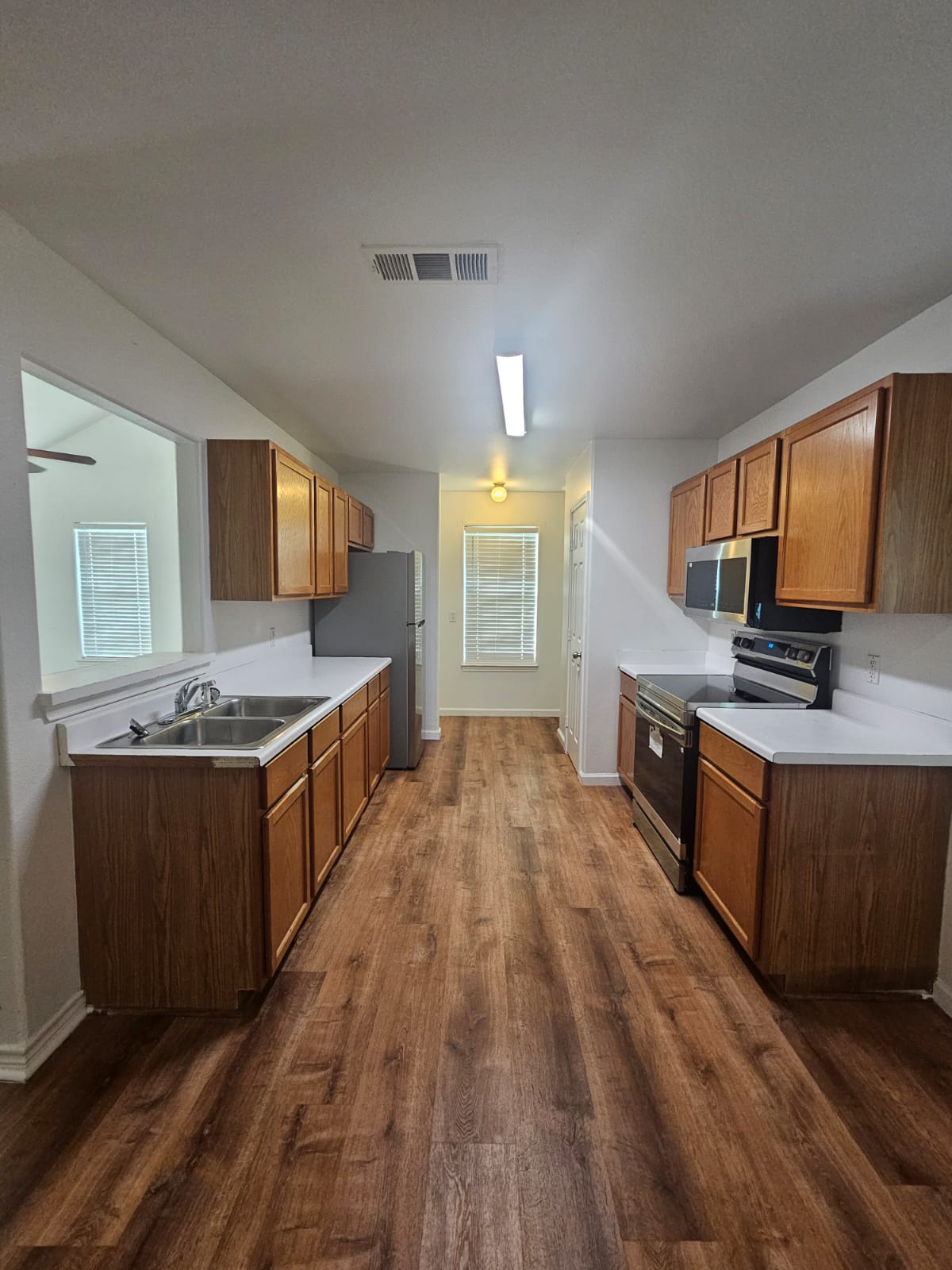 606 Trinity Street Lockhart, TX 78644 - Photo 7 of 23 A well-equipped kitchen features durable flooring and abundant cabinetry for storage.