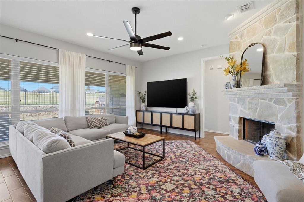 7224 Prestwick Terrace Benbrook, TX 76126 - Photo 2 of 26 Enjoy incredible natural light through a wall of floor-to-ceiling windows, creating a sun-drenched living space with a picturesque view of the private backyard.