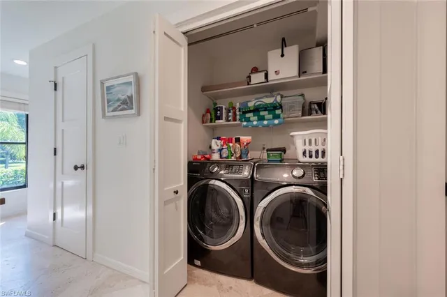 a view of storage and utility room with washer and dryer