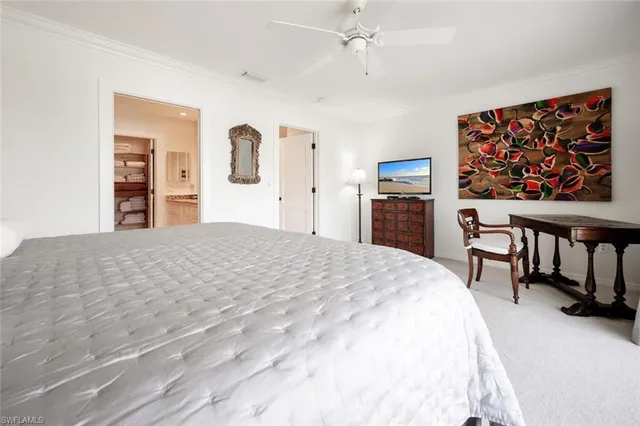 a bedroom with a bed and a desk