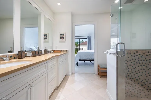 a spacious bathroom with a double vanity sink a mirror and a bathtub