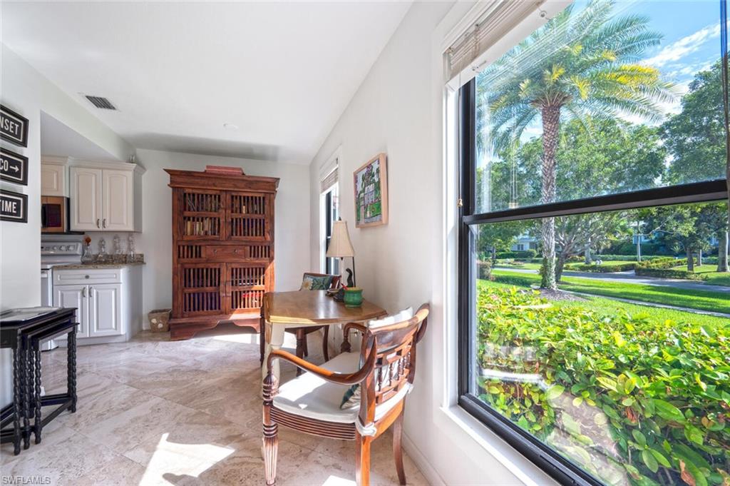 1080 6th Street South Naples, FL 34102 - Photo 6 of 33 a dining room with furniture and a floor to ceiling window