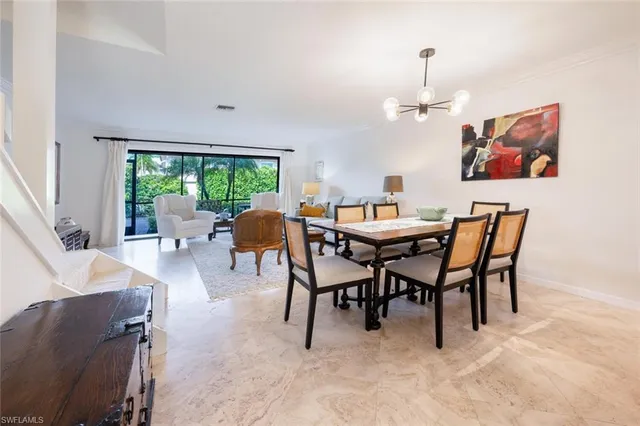 a view of a dining room with furniture a livingroom and outdoor view