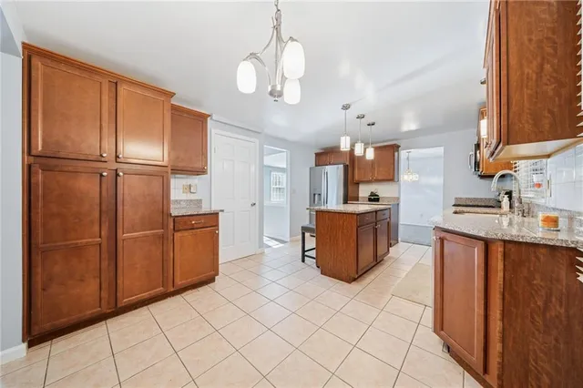 a kitchen with stainless steel appliances granite countertop a refrigerator and a sink